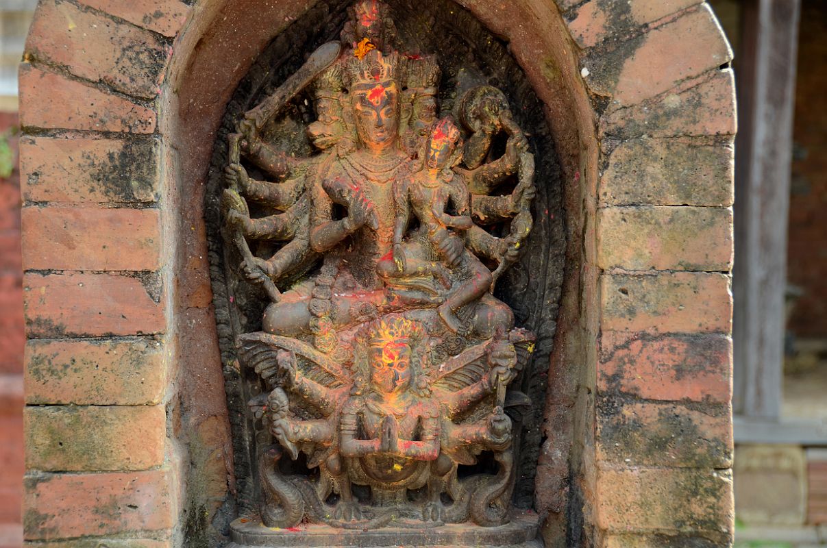 Kathmandu Changu Narayan 31 10 Armed Vaikuntha Vishnu With Lakshmi On His Lap Rides On Garuda In The North East Corner Of Changu Narayan A 16C statue of Vaikuntha Vishnu with 10 arms and 4 heads, including two boar heads, and Lakshmi (Laxmi) on his lap rides a six-armed Garuda in the north east corner of Changu Narayan.